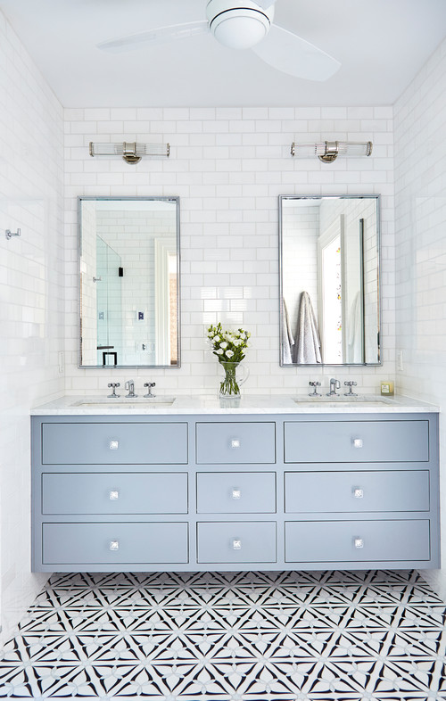 Soft Blue Serenity: Bathroom Storage with Glossy White Subway Tiles and Patterned Floor