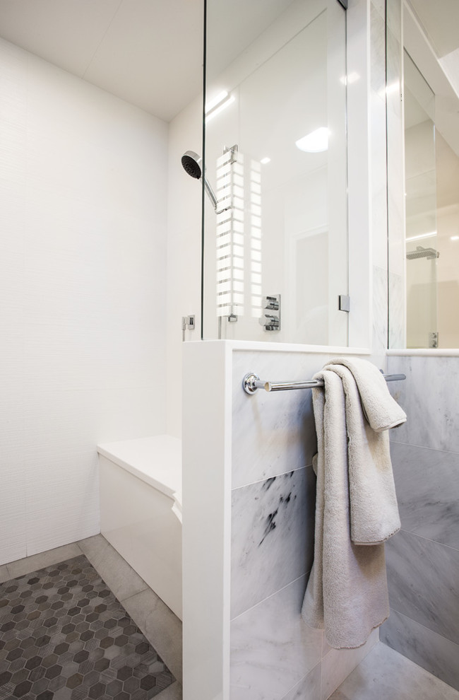 Inspiration for a large contemporary shower room bathroom in Salt Lake City with flat-panel cabinets, light wood cabinets, an alcove bath, a shower/bath combination, a one-piece toilet, white tiles, ceramic tiles, beige walls, porcelain flooring, a submerged sink, solid surface worktops, beige floors and an open shower.