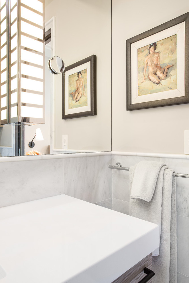Example of a large trendy 3/4 white tile and ceramic tile porcelain tile and beige floor bathroom design in Salt Lake City with flat-panel cabinets, light wood cabinets, a one-piece toilet, beige walls, an undermount sink and solid surface countertops