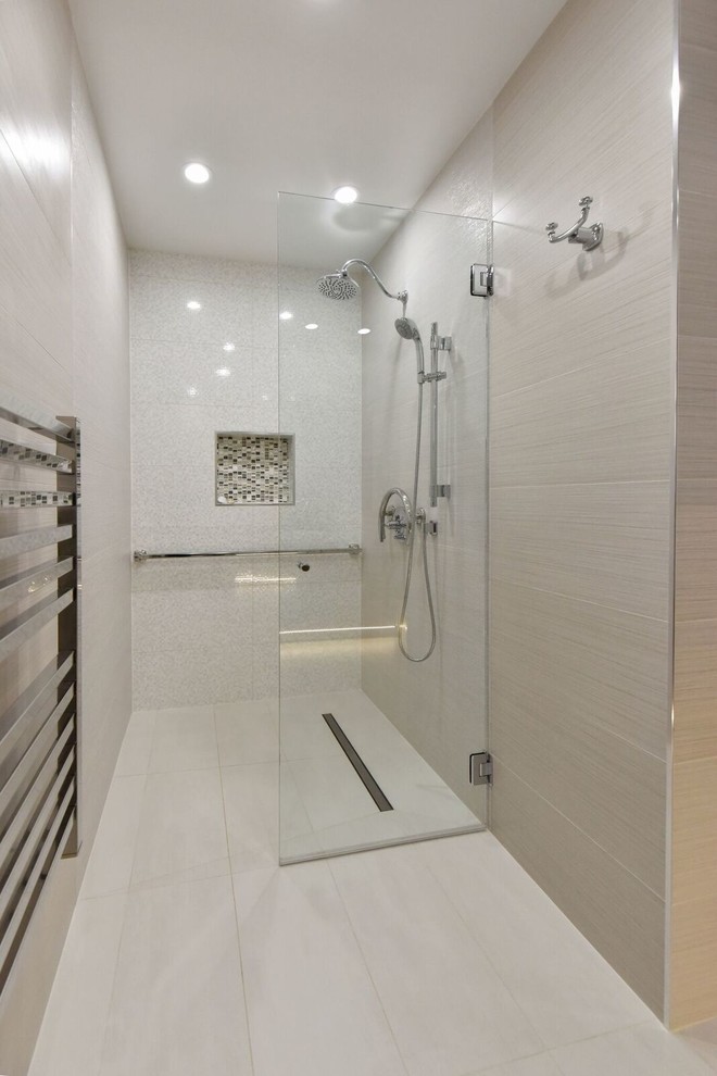 Design ideas for a large contemporary ensuite bathroom in DC Metro with glass-front cabinets, beige cabinets, a built-in shower, a bidet, beige tiles, ceramic tiles, beige walls, ceramic flooring, a vessel sink, recycled glass worktops, beige floors and a hinged door.