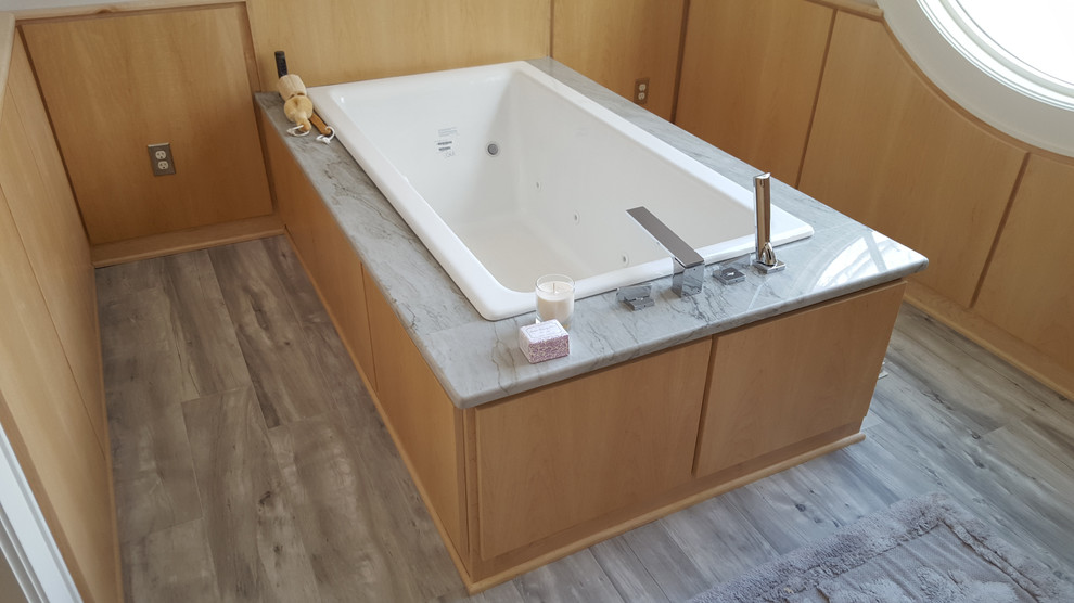 Expansive contemporary ensuite bathroom in New York with flat-panel cabinets, light wood cabinets, a built-in bath, multi-coloured tiles, ceramic tiles, white walls, ceramic flooring and marble worktops.