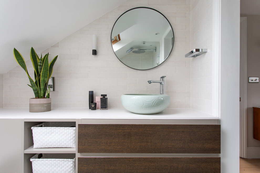 Inspiration for a small contemporary ensuite bathroom in London with flat-panel cabinets, dark wood cabinets, a corner shower, beige tiles, porcelain tiles, a vessel sink, solid surface worktops, an open shower, white worktops, a single sink and a built in vanity unit.