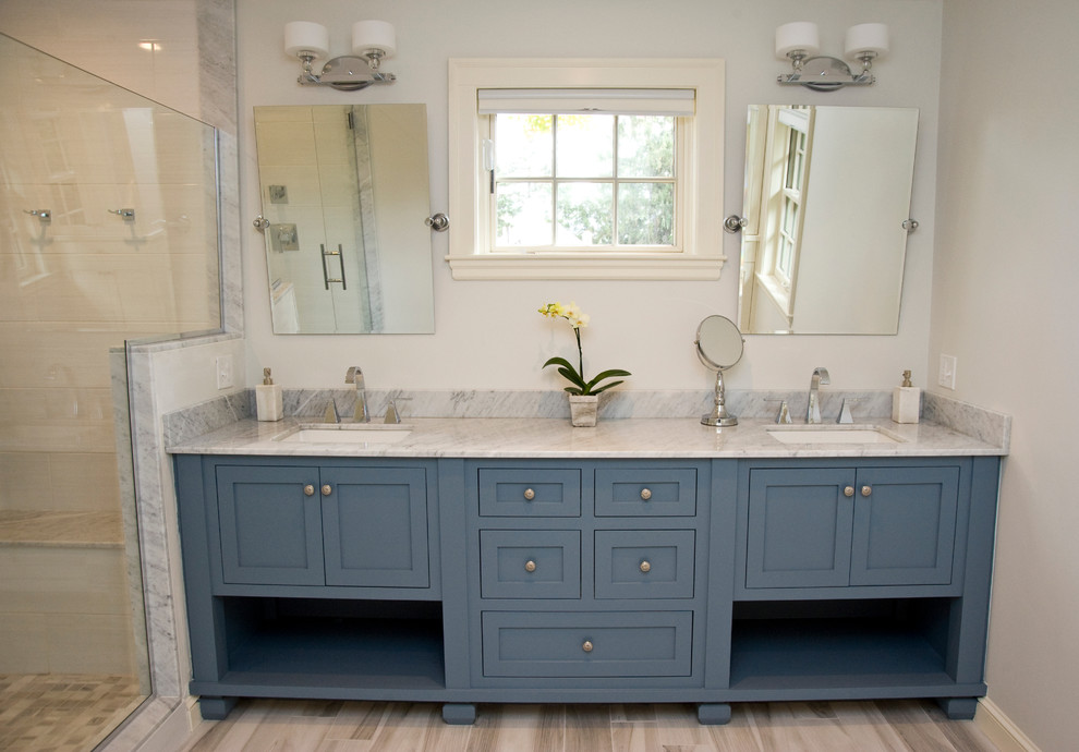 Photo of a large traditional ensuite bathroom in Boston with shaker cabinets, blue cabinets, marble worktops, multi-coloured tiles, blue walls and light hardwood flooring.