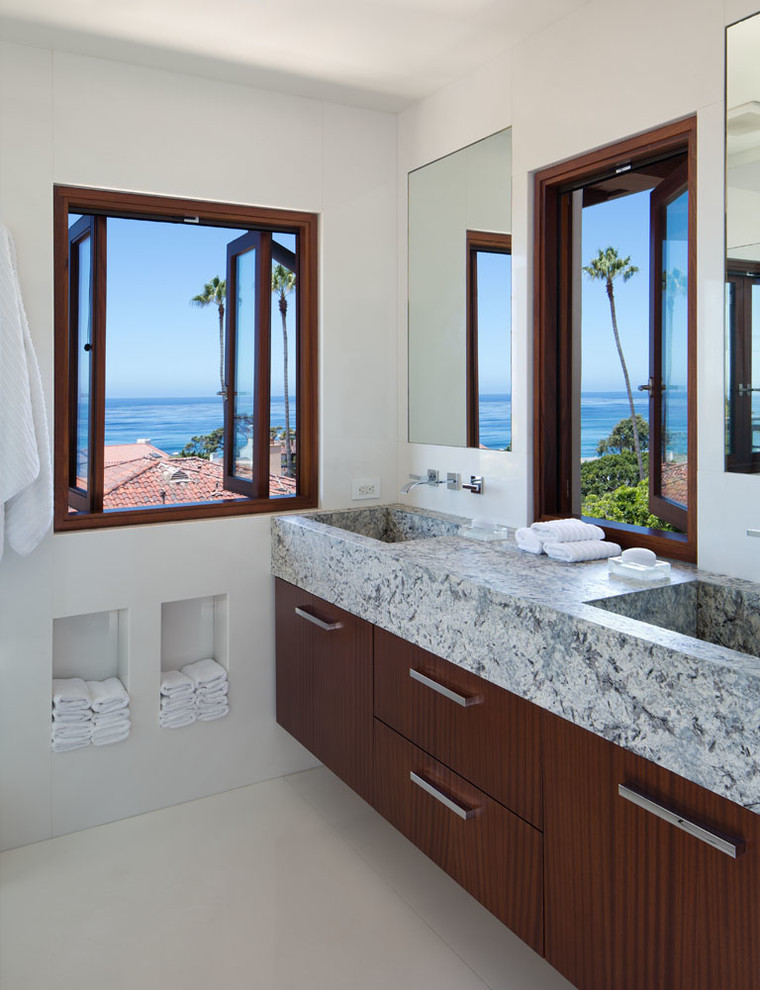Photo of a large traditional ensuite bathroom in San Diego with flat-panel cabinets, an integrated sink, dark wood cabinets, granite worktops, an alcove shower, white walls and marble flooring.