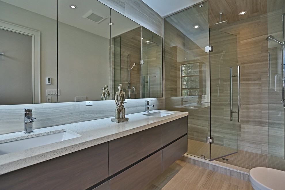 Inspiration for a mid-sized contemporary master beige tile and stone tile limestone floor bathroom remodel in Toronto with an undermount sink, flat-panel cabinets, dark wood cabinets, quartz countertops, a wall-mount toilet and white walls