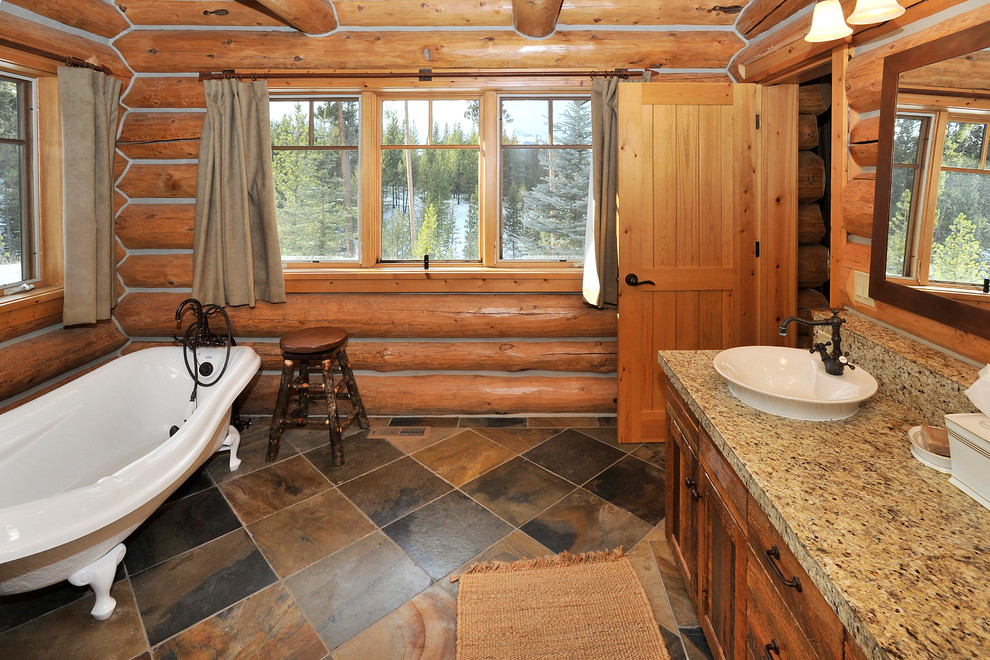 Bathroom - large rustic master multicolored tile and stone tile slate floor bathroom idea in Other with a vessel sink, shaker cabinets, distressed cabinets, granite countertops and a two-piece toilet