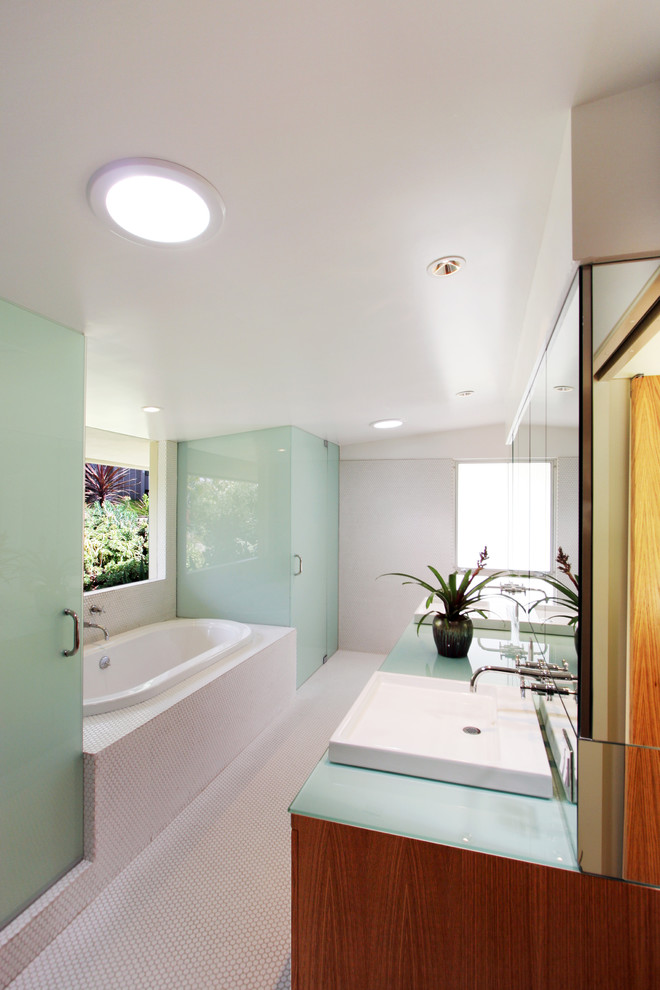 Inspiration for a large mid-century modern master white tile and mosaic tile mosaic tile floor and white floor bathroom remodel in Los Angeles with flat-panel cabinets, medium tone wood cabinets, white walls, a vessel sink, glass countertops and a hinged shower door
