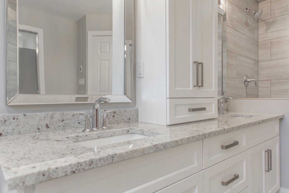 Example of a mid-sized minimalist master bathroom design in Other with shaker cabinets, white cabinets, a one-piece toilet, gray walls, an undermount sink and granite countertops