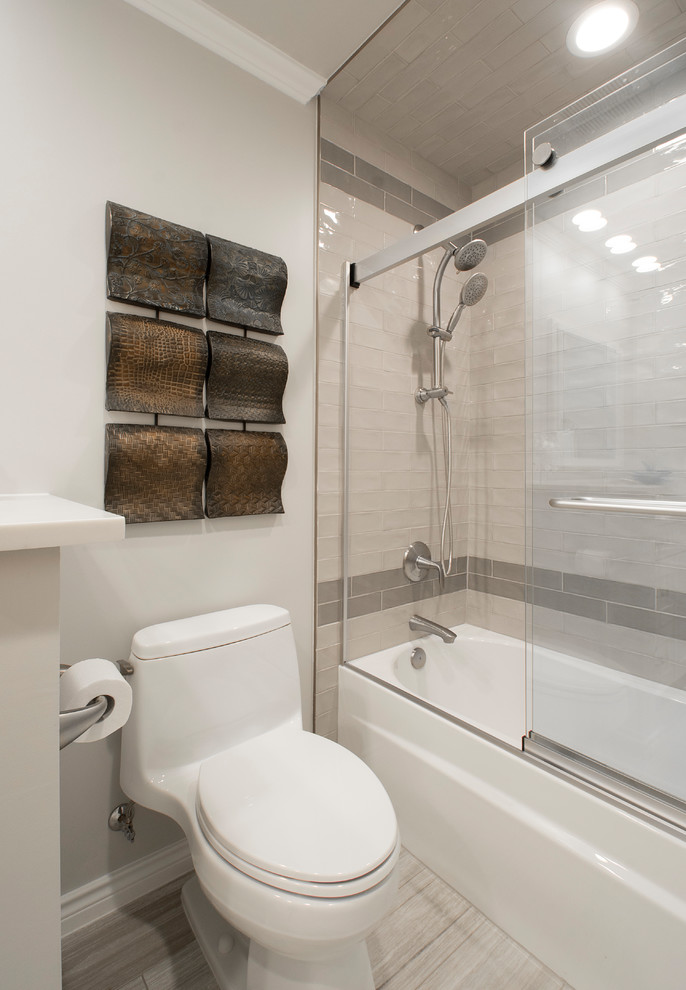 This is an example of a medium sized traditional ensuite bathroom in Dallas with flat-panel cabinets, grey tiles, grey walls, marble flooring, a submerged sink, engineered stone worktops, beige floors, white cabinets, an alcove bath, a shower/bath combination, a one-piece toilet, marble tiles and a sliding door.