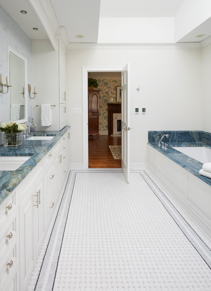 Bild på ett stort vintage en-suite badrum, med luckor med upphöjd panel, vita skåp, ett undermonterat badkar, vit kakel, marmorkakel, granitbänkskiva, en hörndusch, en toalettstol med hel cisternkåpa, blå väggar, mosaikgolv, ett undermonterad handfat, flerfärgat golv och dusch med gångjärnsdörr