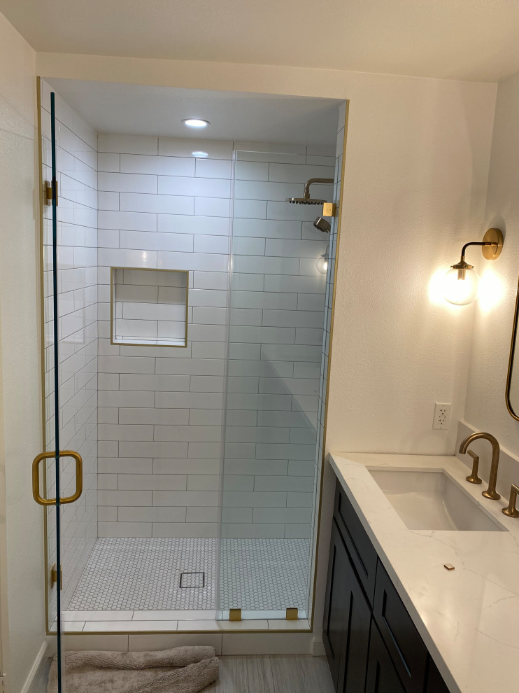 This is an example of a medium sized classic ensuite bathroom in Los Angeles with shaker cabinets, dark wood cabinets, an alcove shower, a one-piece toilet, yellow tiles, porcelain tiles, beige walls, porcelain flooring, a submerged sink, engineered stone worktops, grey floors, a hinged door and white worktops.