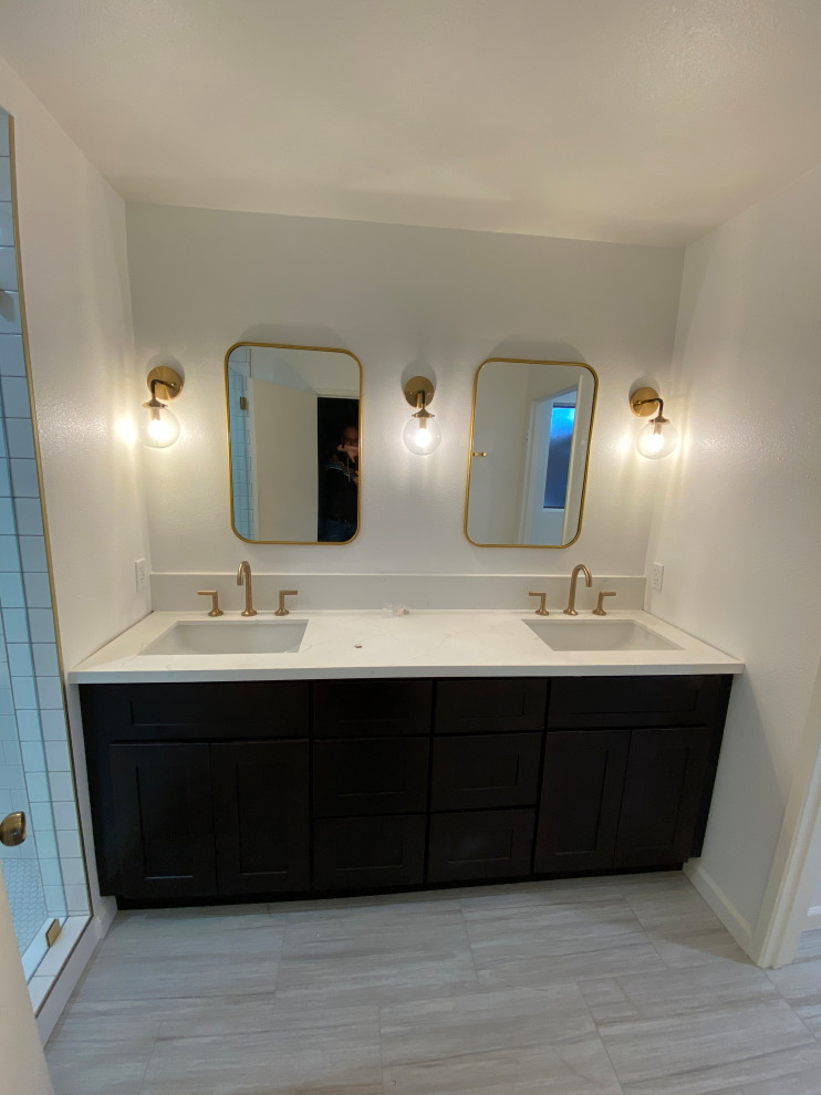 Medium sized traditional ensuite bathroom in Los Angeles with shaker cabinets, dark wood cabinets, an alcove shower, a one-piece toilet, yellow tiles, porcelain tiles, beige walls, porcelain flooring, a submerged sink, engineered stone worktops, grey floors, a hinged door and white worktops.