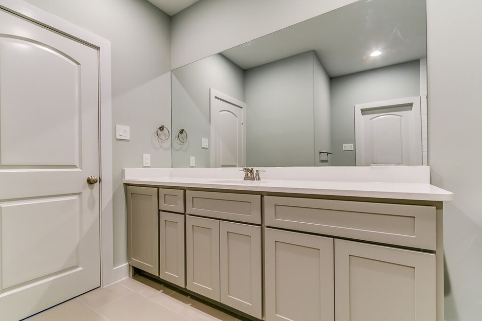 Transitional white tile beige floor bathroom photo in Houston with shaker cabinets, gray cabinets and gray walls