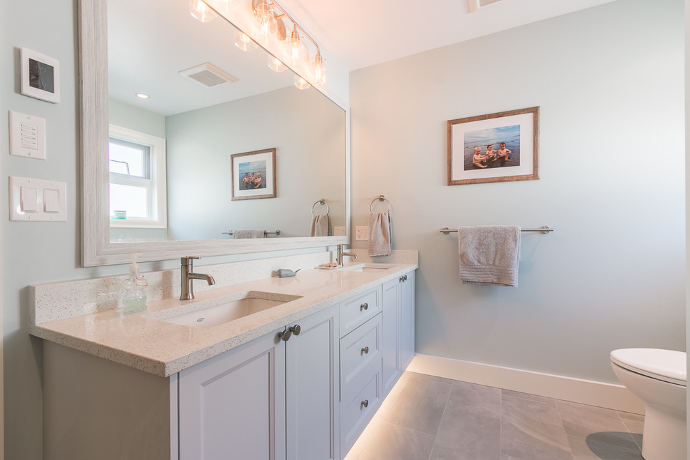 Design ideas for a medium sized classic ensuite bathroom in Vancouver with recessed-panel cabinets, grey cabinets, an alcove bath, a shower/bath combination, white tiles, porcelain tiles, grey walls, concrete flooring, granite worktops, grey floors, a shower curtain and grey worktops.