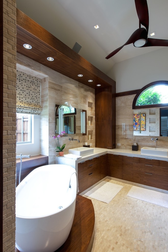 Example of a mid-sized minimalist master beige tile and stone tile marble floor bathroom design in Dallas with a wall-mount sink, flat-panel cabinets, medium tone wood cabinets, quartz countertops, a wall-mount toilet and beige walls