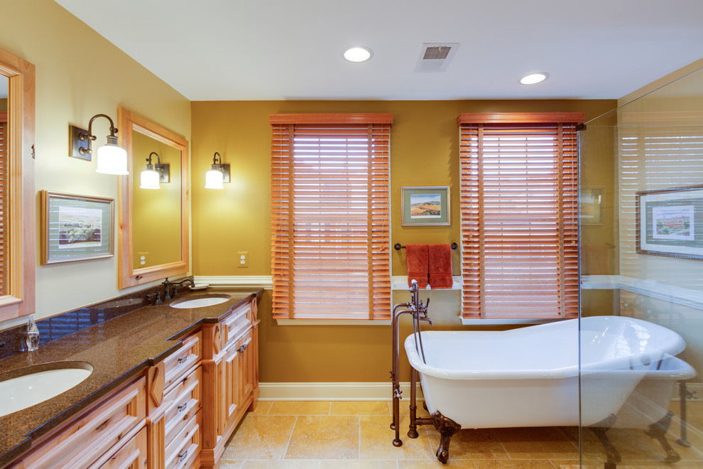 Design ideas for a mediterranean bathroom in DC Metro with a claw-foot bath and feature lighting.