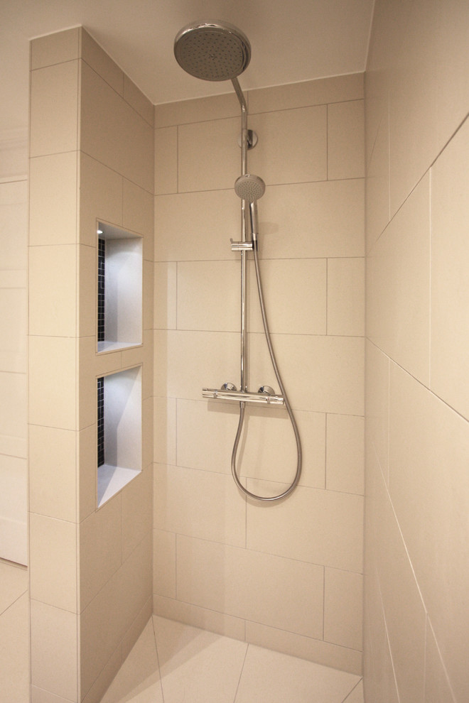 This is an example of a small contemporary shower room bathroom in London with freestanding cabinets, black cabinets, a walk-in shower, a one-piece toilet, black tiles, glass tiles, white walls, porcelain flooring and tiled worktops.