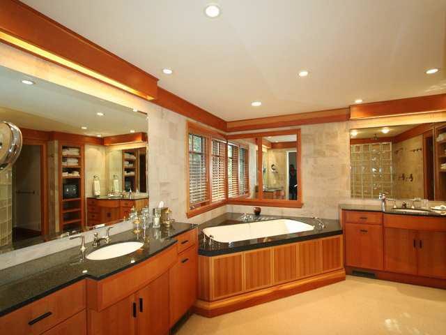 Foto på ett stort amerikanskt en-suite badrum, med släta luckor, bruna skåp, ett hörnbadkar, beige kakel, travertinkakel, bänkskiva i kvarts, en hörndusch, beige väggar, betonggolv, ett undermonterad handfat, beiget golv och med dusch som är öppen