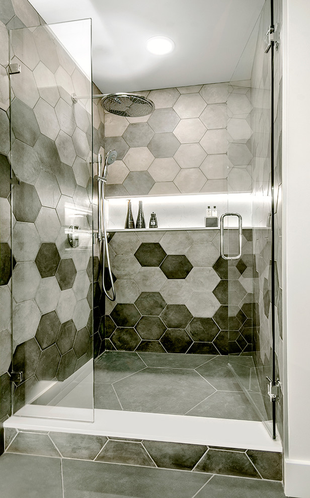 Example of a mid-sized minimalist gray tile and porcelain tile porcelain tile and gray floor bathroom design in Vancouver with flat-panel cabinets, light wood cabinets, white walls, an integrated sink, quartz countertops, a hinged shower door and gray countertops