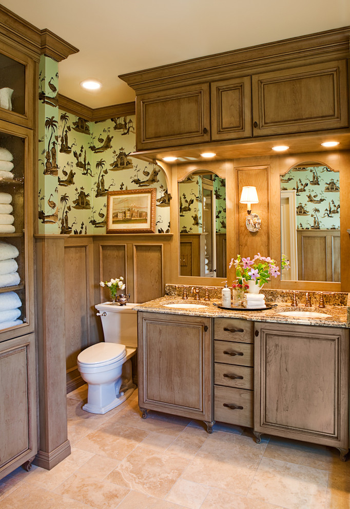 Klassisk inredning av ett mellanstort en-suite badrum, med luckor med infälld panel, skåp i mellenmörkt trä, ett fristående badkar, en öppen dusch, beige kakel, porslinskakel, flerfärgade väggar, travertin golv och ett undermonterad handfat
