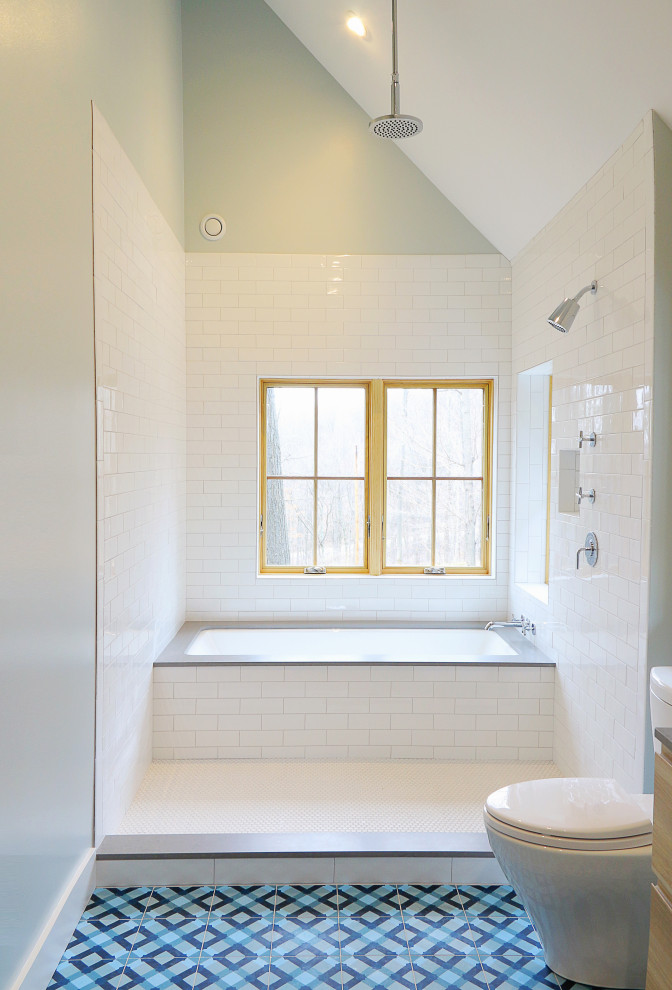 Example of a mid-sized danish master white tile and subway tile mosaic tile floor, blue floor, double-sink and vaulted ceiling bathroom design in Other with flat-panel cabinets, light wood cabinets, a two-piece toilet, green walls, an undermount sink, quartz countertops, gray countertops and a built-in vanity