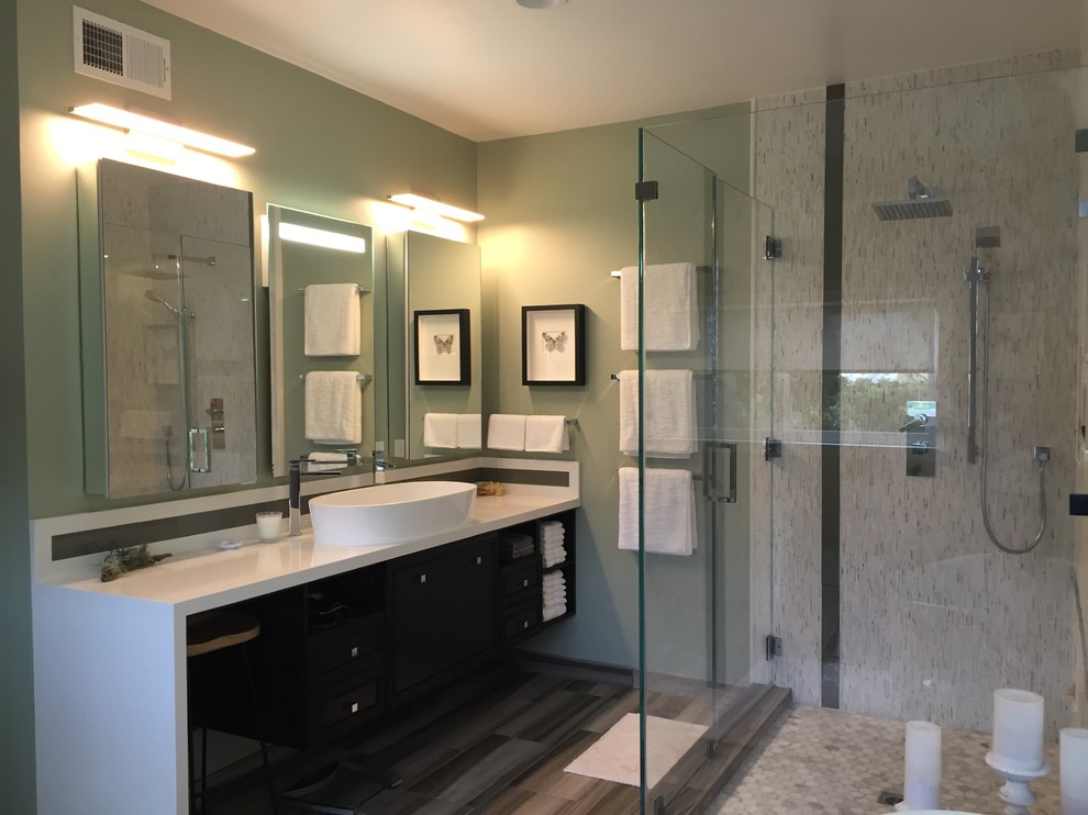 Large minimalist master multicolored tile and glass tile porcelain tile bathroom photo in Los Angeles with a vessel sink, flat-panel cabinets, brown cabinets, solid surface countertops, a one-piece toilet and green walls