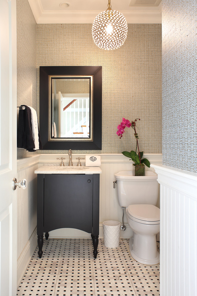 Klassisk inredning av ett litet badrum, med svarta skåp, svart och vit kakel, stenkakel, blå väggar, marmorgolv, ett undermonterad handfat, granitbänkskiva och släta luckor