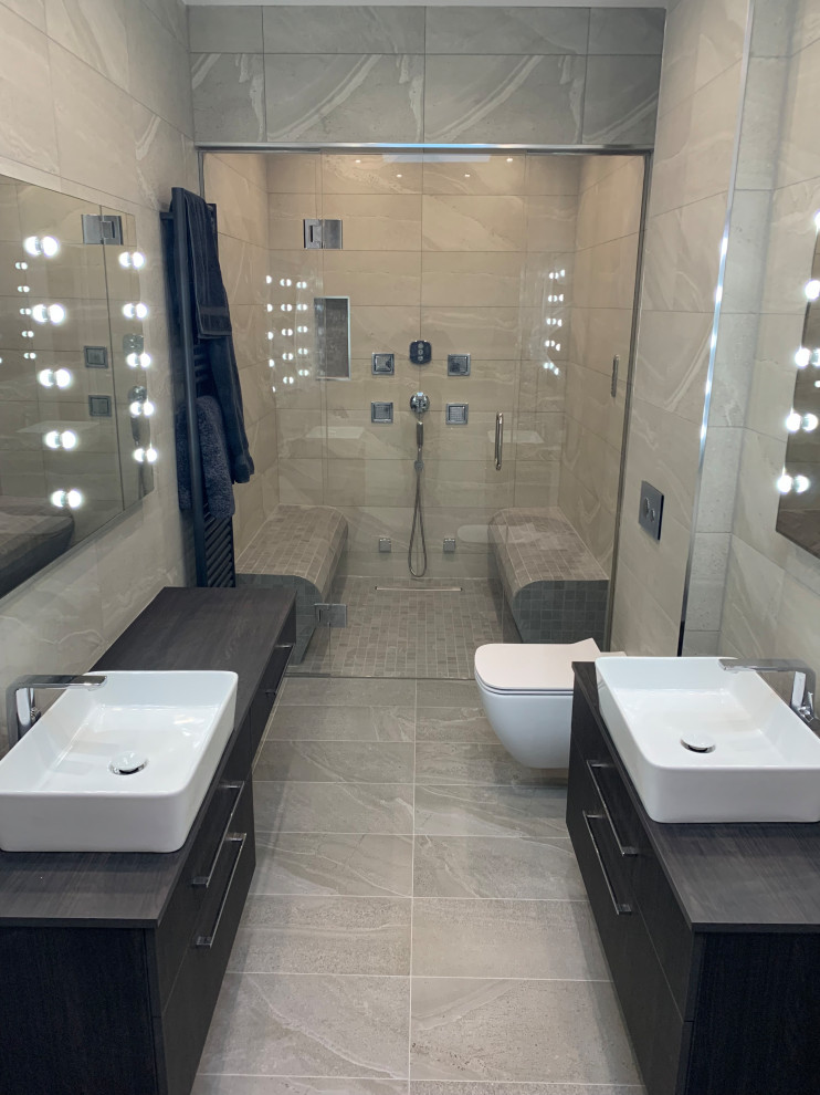 Exempel på ett stort modernt en-suite badrum, med släta luckor, skåp i mörkt trä, ett badkar i en alkov, våtrum, en vägghängd toalettstol, grå kakel, porslinskakel, grå väggar, klinkergolv i porslin, ett fristående handfat, laminatbänkskiva, grått golv och dusch med gångjärnsdörr