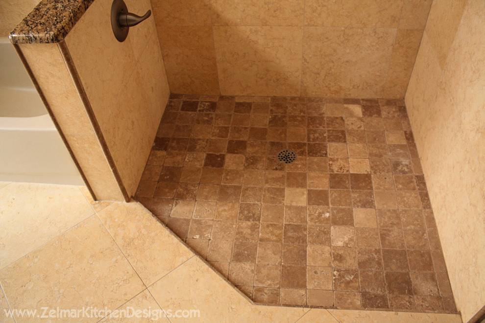 Example of a large classic master brown tile and stone tile travertine floor doorless shower design in Orlando with an undermount sink, recessed-panel cabinets, dark wood cabinets and granite countertops