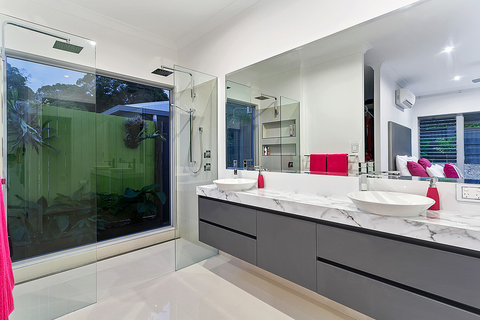Medium sized modern bathroom in Cairns with a vessel sink, grey cabinets, laminate worktops, a double shower, porcelain tiles and porcelain flooring.