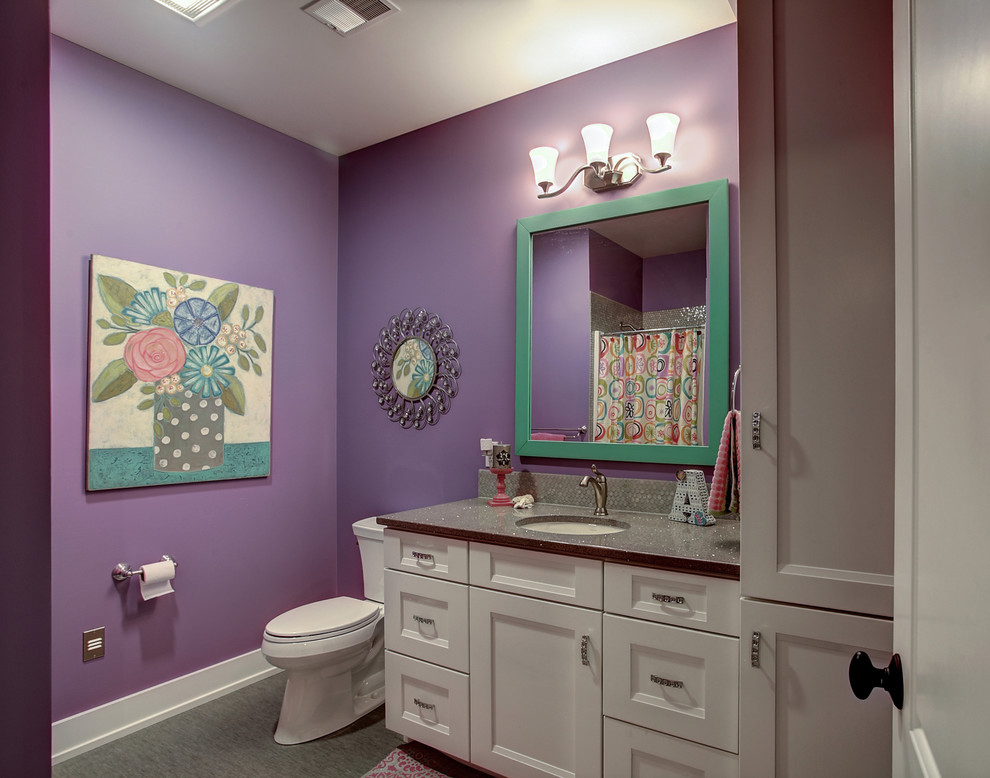 Example of an arts and crafts kids' ceramic tile alcove shower design in Grand Rapids with shaker cabinets, white cabinets, solid surface countertops, a two-piece toilet and purple walls