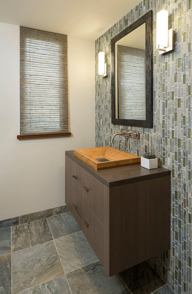Bathroom - mid-sized modern 3/4 blue tile, gray tile, green tile and matchstick tile slate floor and gray floor bathroom idea in San Diego with flat-panel cabinets, medium tone wood cabinets, a two-piece toilet, beige walls, a trough sink and solid surface countertops