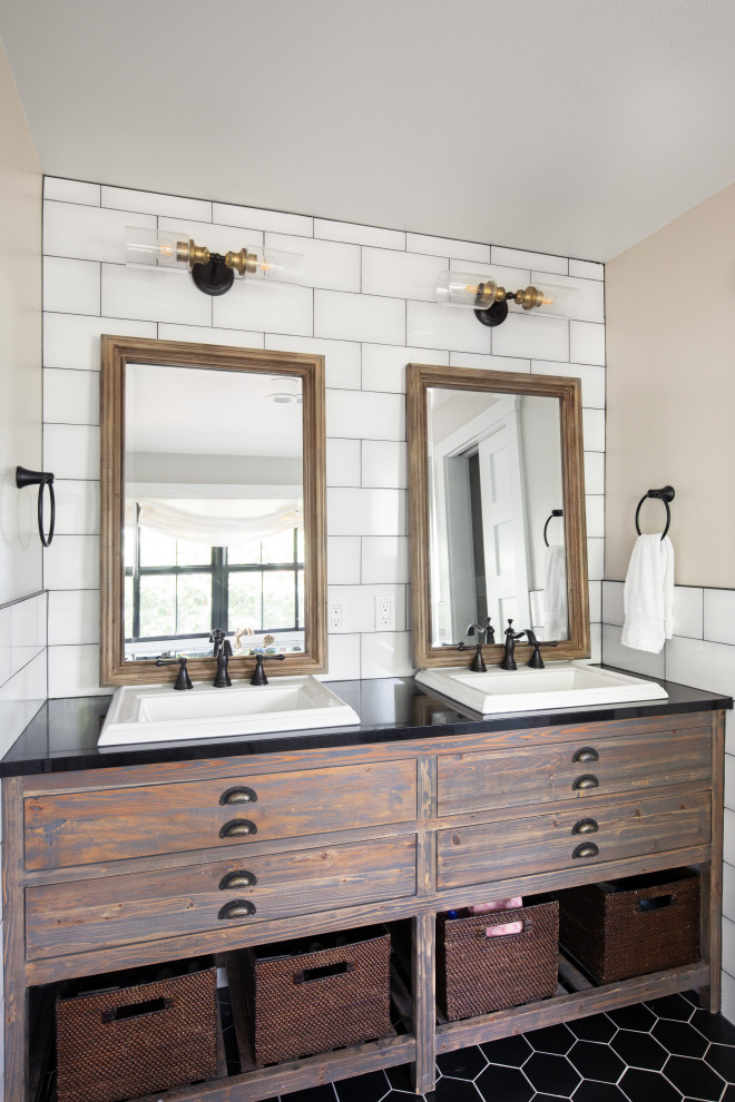Photo of a medium sized rural bathroom in Seattle with flat-panel cabinets, brown cabinets, white tiles, beige walls, porcelain flooring, a built-in sink, black floors and black worktops.