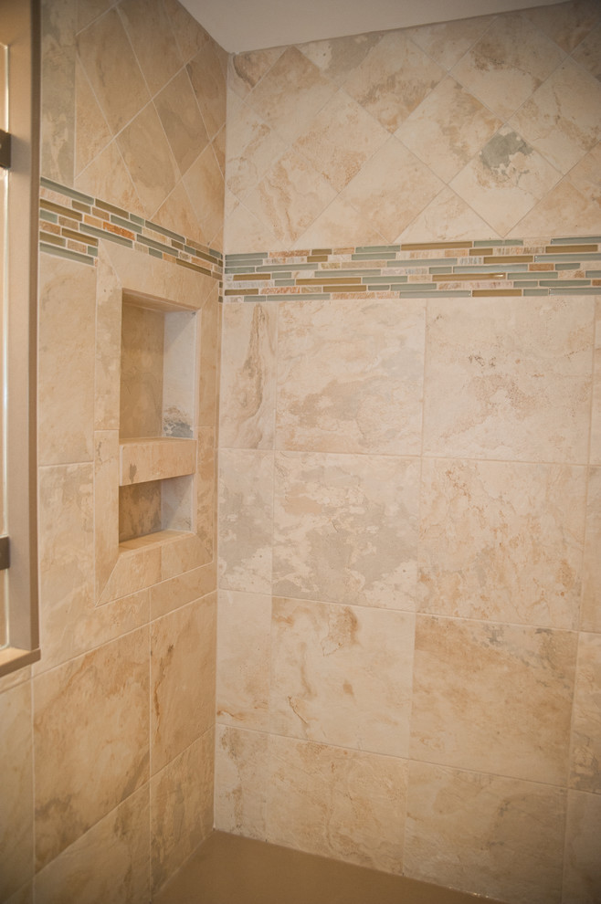 Mid-sized elegant 3/4 stone tile porcelain tile alcove shower photo in New York with shaker cabinets, dark wood cabinets, beige walls, an undermount sink and quartz countertops