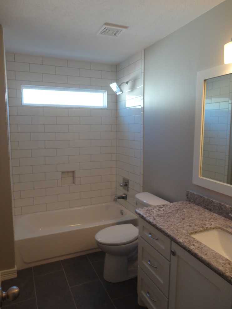 This is an example of a large classic bathroom in Houston with a submerged sink, shaker cabinets, white cabinets, granite worktops, an alcove bath, a corner shower, a two-piece toilet, white tiles, ceramic tiles, grey walls and ceramic flooring.
