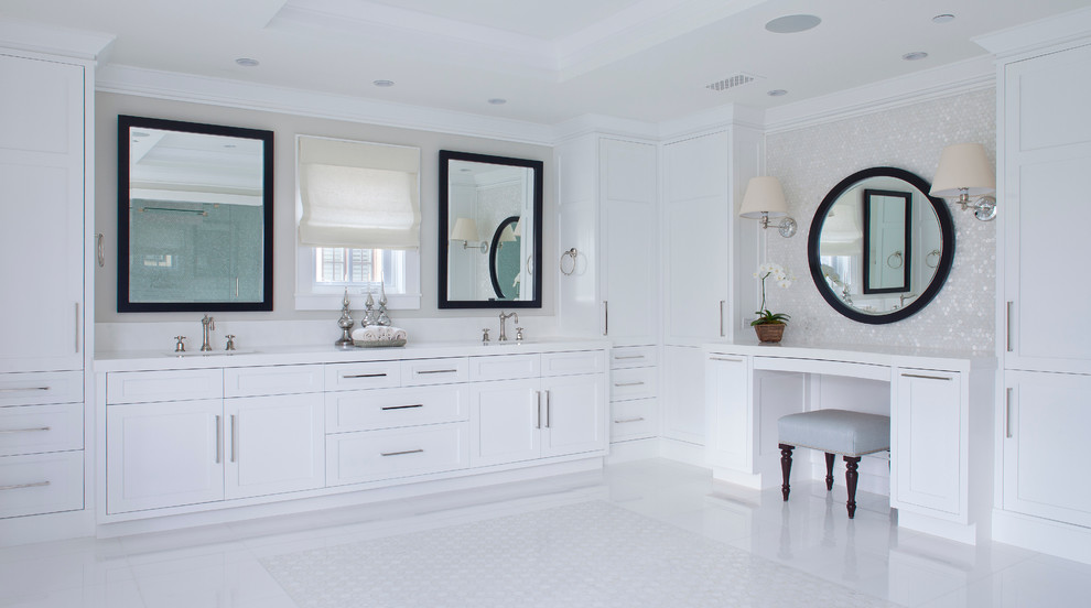 Стильный дизайн: большая ванная комната в стиле неоклассика (современная классика) с врезной раковиной, фасадами с утопленной филенкой, белыми фасадами, мраморной столешницей, отдельно стоящей ванной, унитазом-моноблоком, серой плиткой, плиткой мозаикой, серыми стенами и мраморным полом - последний тренд