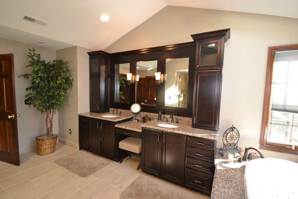 Large transitional master black tile and porcelain tile porcelain tile bathroom photo in Columbus with an undermount sink, recessed-panel cabinets, dark wood cabinets, granite countertops, a one-piece toilet and beige walls