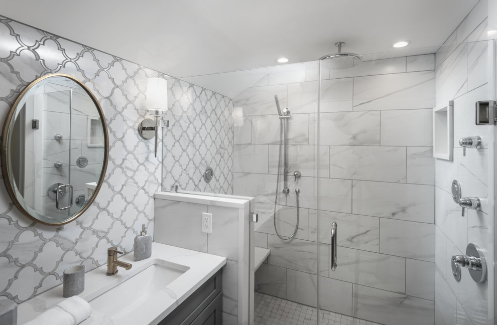 Design ideas for a medium sized traditional ensuite bathroom in Philadelphia with shaker cabinets, grey cabinets, a double shower, a wall mounted toilet, white tiles, porcelain tiles, grey walls, porcelain flooring, a built-in sink, quartz worktops, white floors, a hinged door, white worktops, a shower bench, double sinks, a built in vanity unit and wallpapered walls.