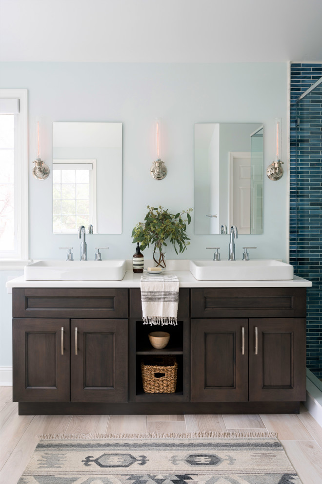 Inspiration for a large traditional ensuite bathroom in Philadelphia with shaker cabinets, dark wood cabinets, a freestanding bath, a corner shower, a two-piece toilet, blue tiles, glass tiles, blue walls, ceramic flooring, a vessel sink, engineered stone worktops, beige floors and a hinged door.