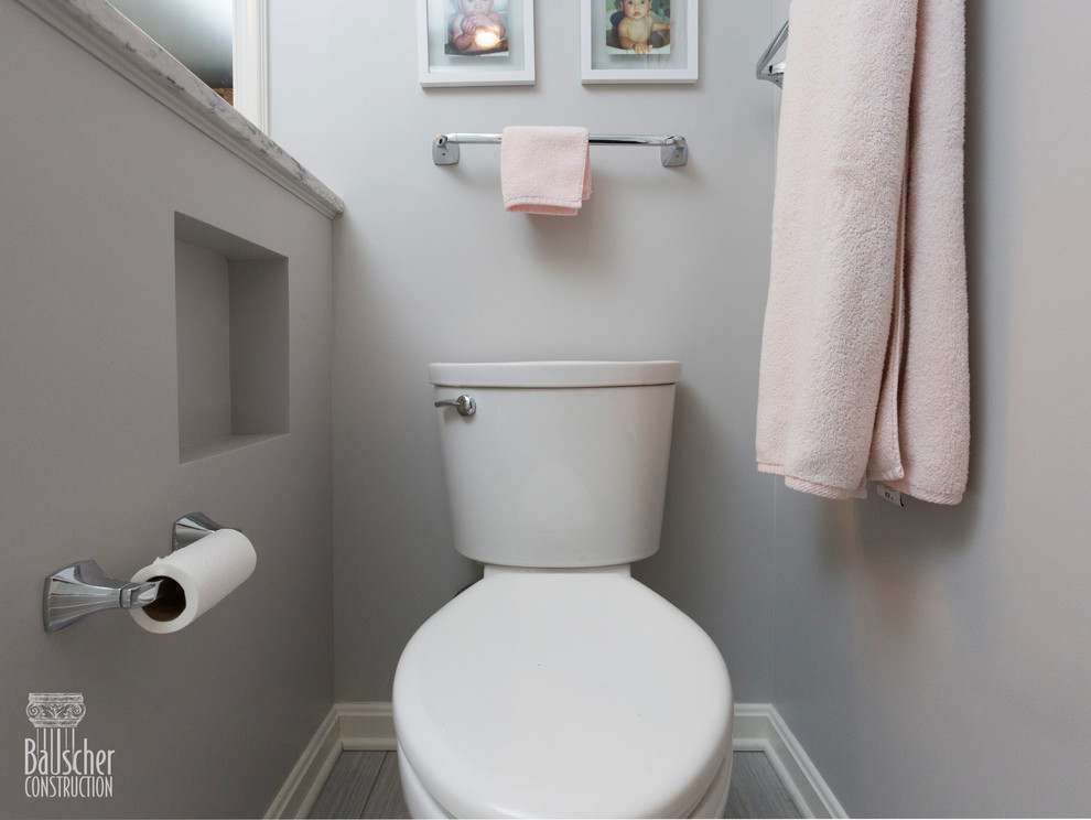 This is an example of a small traditional family bathroom in Cincinnati with flat-panel cabinets, grey cabinets, an alcove bath, a shower/bath combination, a one-piece toilet, white tiles, porcelain tiles, grey walls, porcelain flooring, a submerged sink, granite worktops, grey floors, a sliding door and grey worktops.