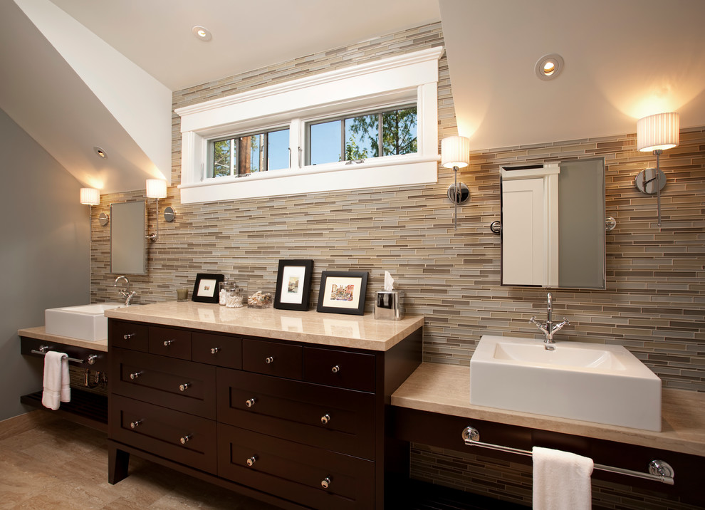 Bathroom - mid-sized transitional master beige tile and glass tile travertine floor bathroom idea in Salt Lake City with a vessel sink, furniture-like cabinets, dark wood cabinets, limestone countertops, a two-piece toilet and gray walls
