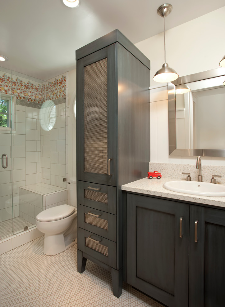 Small traditional shower room bathroom in Salt Lake City with a built-in sink, shaker cabinets, blue cabinets, solid surface worktops, an alcove shower, white tiles, ceramic tiles, white walls and ceramic flooring.