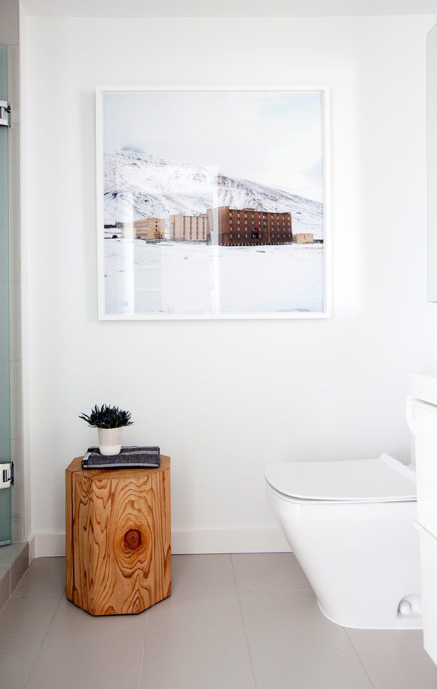 Inspiration for a small scandinavian shower room bathroom in Vancouver with an integrated sink, flat-panel cabinets, white cabinets, an alcove bath, an alcove shower, a one-piece toilet, grey tiles, porcelain tiles, white walls and porcelain flooring.