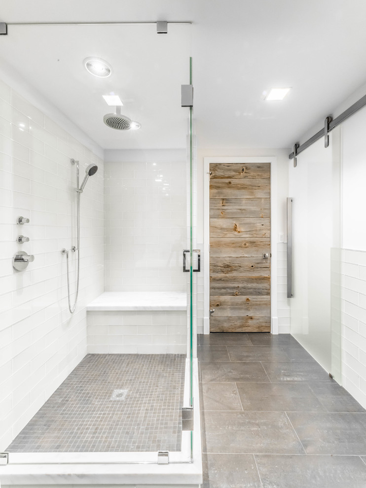 Medium sized modern shower room bathroom in New York with flat-panel cabinets, distressed cabinets, a corner shower, a two-piece toilet, white tiles, glass tiles, white walls, porcelain flooring, a submerged sink and marble worktops.