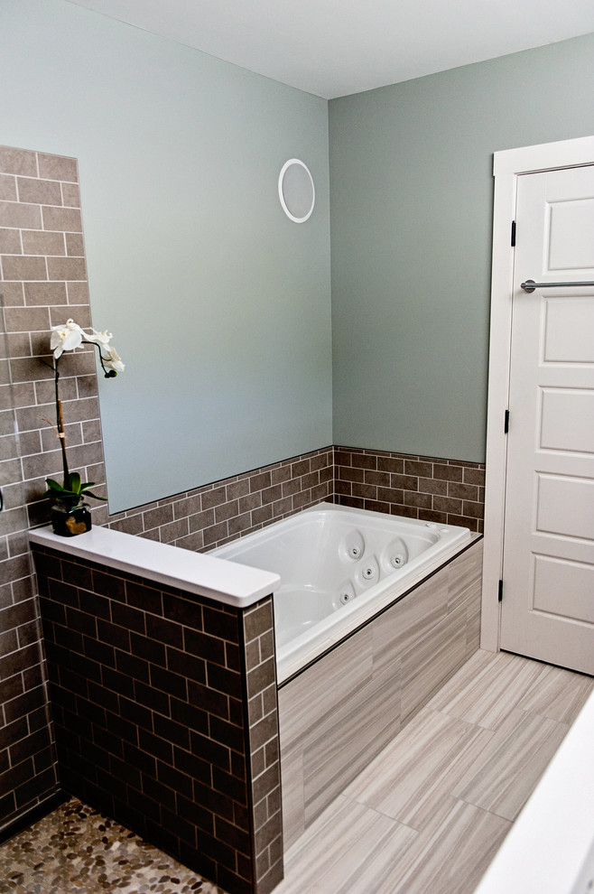 This is an example of a small modern ensuite bathroom in Portland Maine with a submerged sink, flat-panel cabinets, dark wood cabinets, engineered stone worktops, a built-in bath, a built-in shower, a two-piece toilet, multi-coloured tiles, metro tiles, green walls and porcelain flooring.
