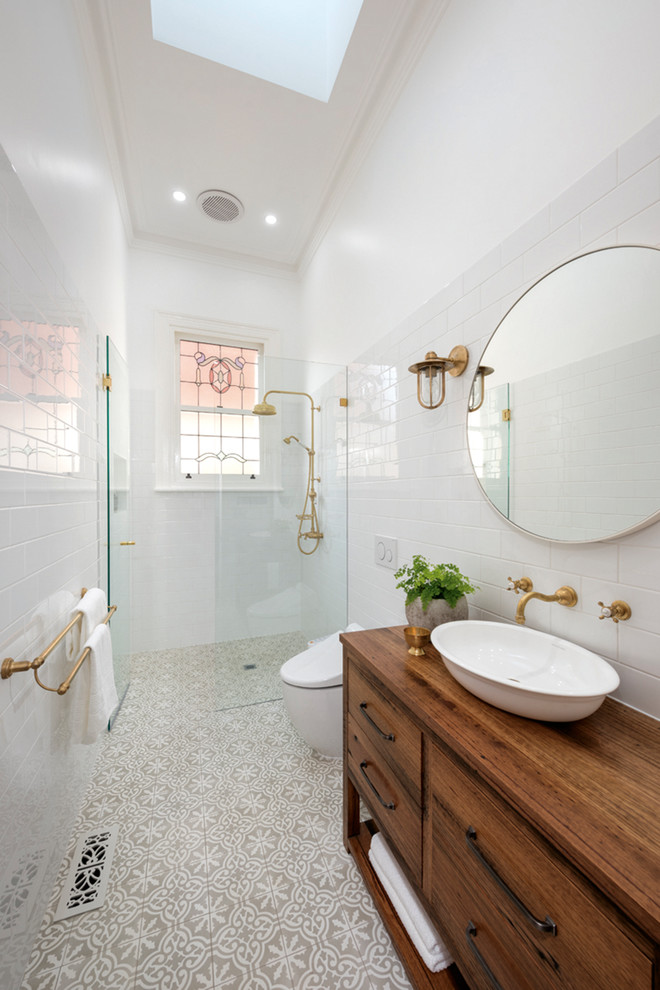 Mid-sized elegant master white tile and porcelain tile concrete floor and multicolored floor bathroom photo in Other with furniture-like cabinets, brown cabinets, a wall-mount toilet, white walls, a vessel sink, wood countertops and brown countertops