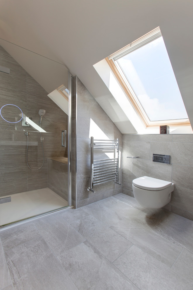 This is an example of a modern ensuite bathroom in Other with flat-panel cabinets, white cabinets, a freestanding bath, a walk-in shower, a wall mounted toilet, beige tiles, porcelain tiles, porcelain flooring, a built-in sink and tiled worktops.