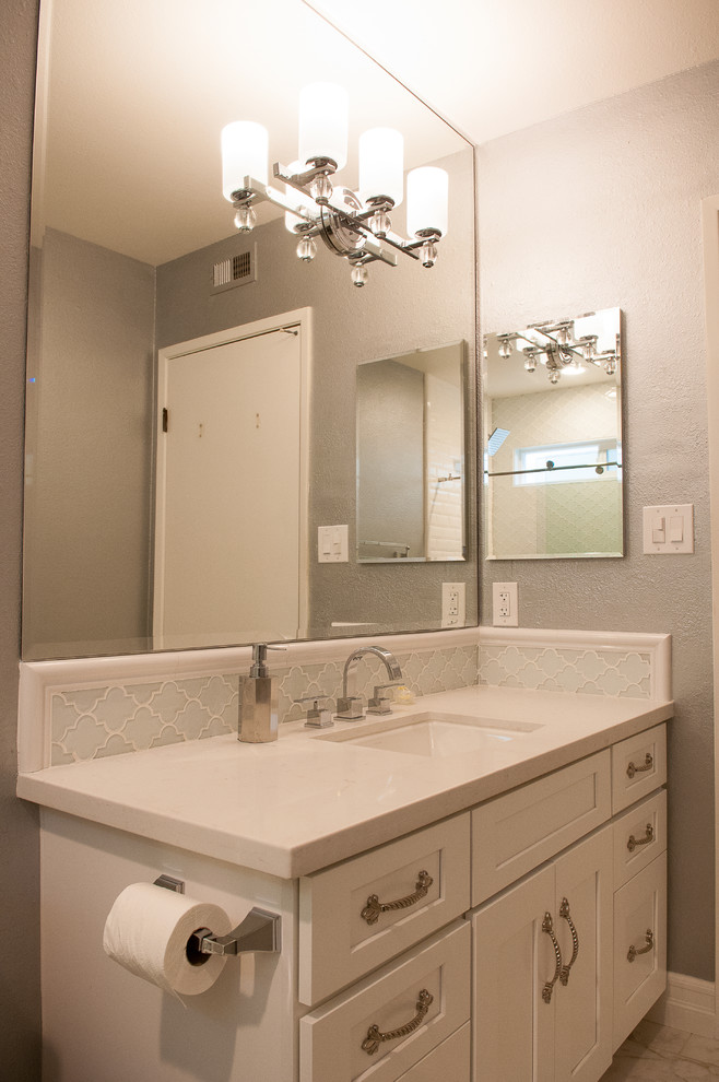 Example of a small classic 3/4 white tile and porcelain tile porcelain tile bathroom design in Other with flat-panel cabinets, white cabinets, gray walls, an undermount sink and marble countertops