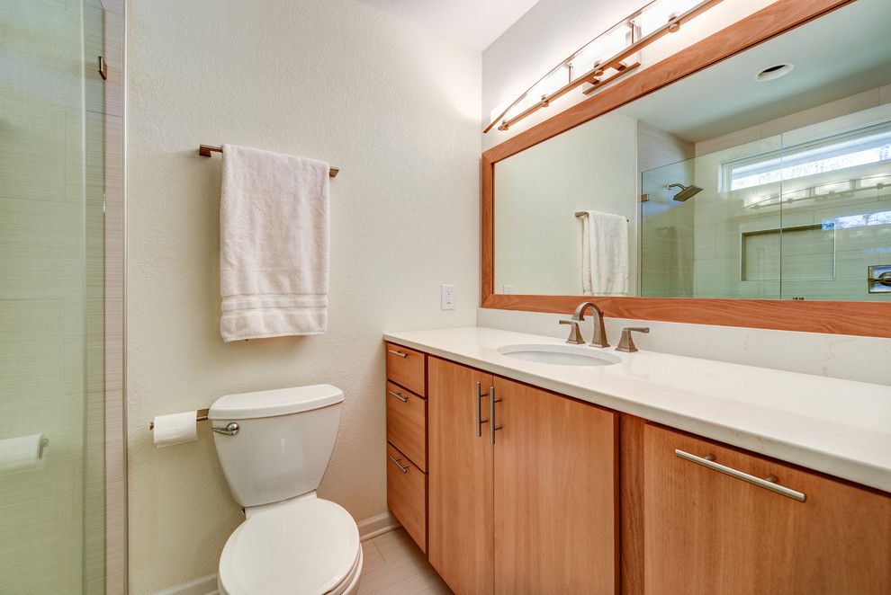 Alcove shower - mid-sized contemporary master ceramic tile and beige tile porcelain tile alcove shower idea in Other with flat-panel cabinets, quartzite countertops, an undermount tub, a two-piece toilet, medium tone wood cabinets, white walls and an undermount sink