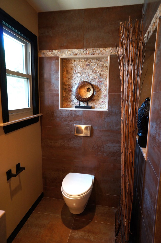 Inredning av ett asiatiskt mellanstort en-suite badrum, med luckor med upphöjd panel, svarta skåp, en dusch i en alkov, en vägghängd toalettstol, bruna väggar, skiffergolv, ett fristående handfat och bänkskiva i kalksten